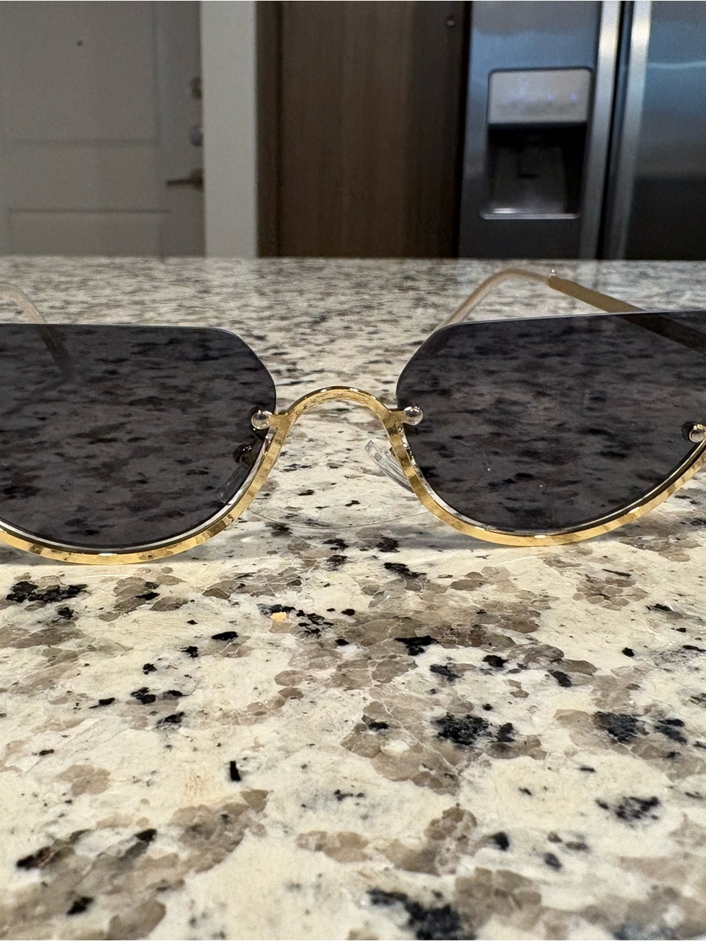 Gold rimmed sunglasses